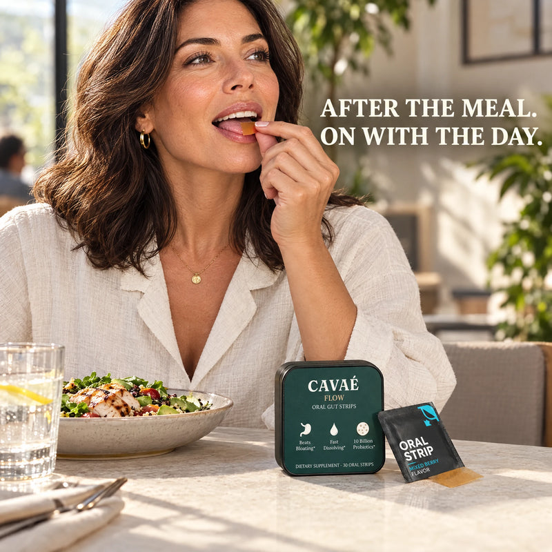 Woman using a CAVAÉ FLOW oral strip at a bright kitchen counter with the product tin nearby.